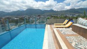 a swimming pool on the roof of a building at Aqua Royal Holiday Apartments Girne in Kyrenia