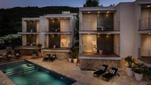 an apartment building with a swimming pool in front of it at Tara's Lodge Hotel in Korčula