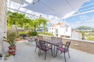 a patio with a table and chairs on a balcony at Guesthouse Tonko in Dubrovnik