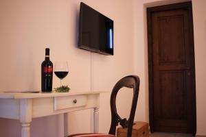 a bottle of wine sitting on a table with a wine glass at Masseria Savoia in Ginosa Marina