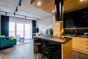 a kitchen with a large island in a room at Apartament WIDOK in Olsztyn
