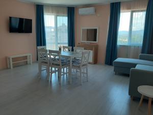 a living room with a table and chairs and a couch at La MER 2 in Tsarevo