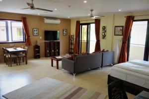 a living room with a couch and a table at Casa Cataleya Bohol Self-service Apartments in Panglao Island