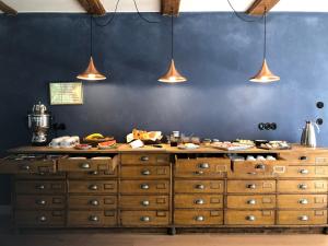 a kitchen with a counter with wooden cabinets and lights at Schweigerhof in Ramsau am Dachstein