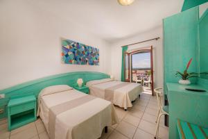 Postel nebo postele na pokoji v ubytování Hotel Marinaro