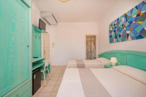 Postel nebo postele na pokoji v ubytování Hotel Marinaro