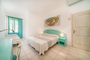 Postel nebo postele na pokoji v ubytování Hotel Marinaro