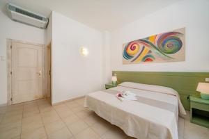 Postel nebo postele na pokoji v ubytování Hotel Marinaro