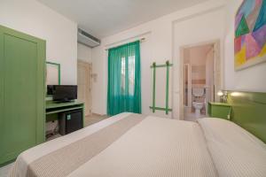 Postel nebo postele na pokoji v ubytování Hotel Marinaro