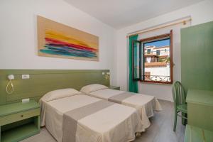 Postel nebo postele na pokoji v ubytování Hotel Marinaro