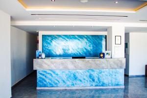 a lobby with a large blue painting on the wall at Sunshine Hotel Tigaki in Tigaki