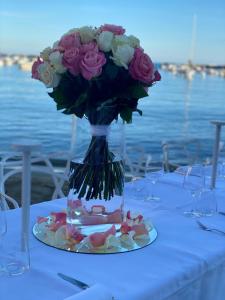 a vase with a bouquet of flowers on a table at Hotel Miramare & Spa in Sestri Levante