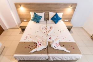 a bed with a heart made out of sprinkles at Tivoli Hotel in Faliraki