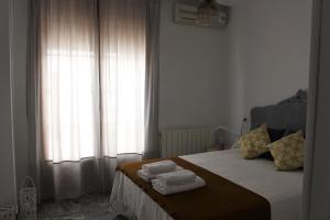 Łóżko lub łóżka w pokoju w obiekcie Alojamiento La Cochera