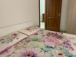 un letto con un piumone floreale sopra di esso di Golden House a Palmi