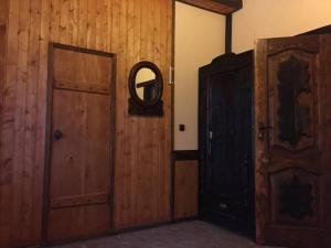 a room with a wooden door and a mirror at Belovodye Hotel in Kamennomostskiy