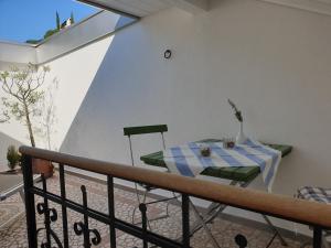 een tafel en stoelen op een balkon bij viaDolceVita - Blaue Gästewohnung in Lana