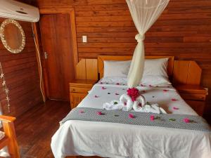 a bed with flowers and stuffed animals on it at East Africa Safaris in Chizavane