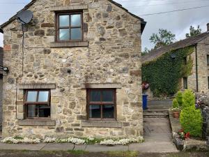 an old stone house with three windows at Fox and Hounds Cottage, Starbotton in Starbotton