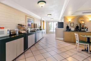 a large kitchen with a counter and a table at La Quinta Inn by Wyndham El Paso West in El Paso