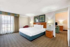 a large hotel room with a bed and a chair at La Quinta Inn by Wyndham El Paso West in El Paso +22 photos