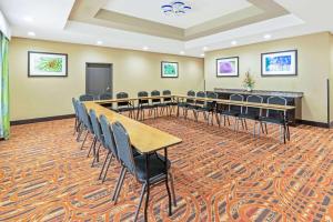 a conference room with tables and chairs and a podium at La Quinta by Wyndham Muskogee in Muskogee