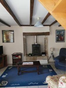 a living room with a table and a fireplace at The Cherries Houehdeu in Naizin