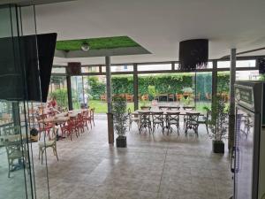 a dining room with tables and chairs and windows at Aparthotel Lucky Family in Ravda