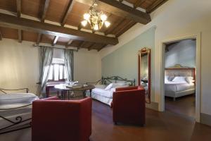 a living room with two beds and a mirror at Palagina la dimora in Figline Valdarno