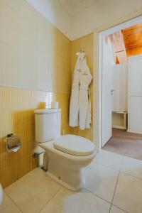 a bathroom with a white toilet in a room at Premier Geneva Hotel in Odesa