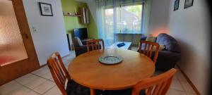 a living room with a wooden table and chairs at Ferienwohnung Bausenbergblick in Niederzissen