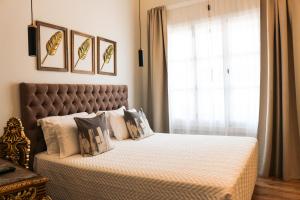 a bedroom with a bed with a large window at 9 Muses Hotel in Larnaka
