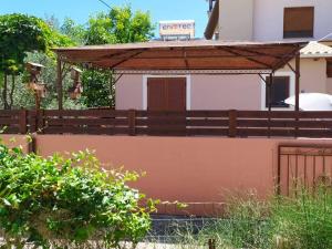 a house with a fence in front of it at Villa Arktos in Nydri