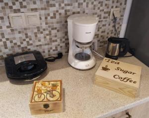 a coffee maker and a book on a counter at Villa Arktos in Nydri +25 photos