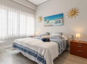 ein Schlafzimmer mit einem Bett und einem großen Fenster in der Unterkunft Prestancia Apartament II by the urban hosts in Bilbao