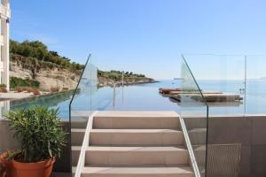 a row of stairs leading up to a balcony overlooking the water at Hotel Chiqui in Santander