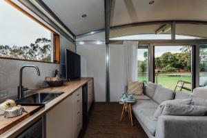a kitchen and living room with a couch in a caravan at The Villas - Barossa in Marananga
