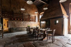 a dining room with a wooden table and chairs at Ostello del Bigallo in Bagno a Ripoli