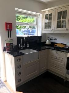 a kitchen with a sink and a window at Holly Tree Cottage in High Etherley +15 photos