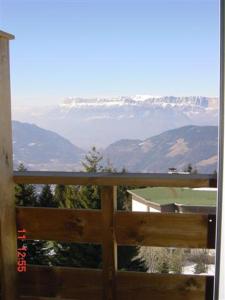 a view of a snow covered mountain from a window at clos des gentianes in Allevard