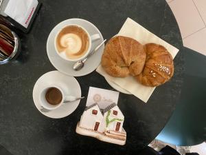 a table with a cup of coffee and a pastry at Nenètte in Locorotondo