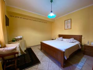 a bedroom with a bed and a table and a chair at B&B A Casa di Nonna in Massa dʼAlbe