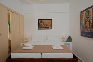 a bedroom with a bed with two towels on it at Elalia Apartments in Hersonissos