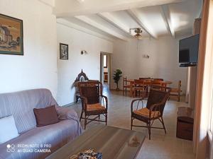 a living room with a couch and a table at U Palmu in Sagone