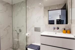 a bathroom with a sink and a shower at Emfasis Loft Spacious and Elegant Heraklion in Heraklio Town