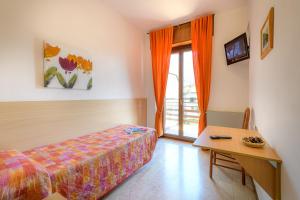 Un pat sau paturi într-o cameră la Hotel La Rotonda