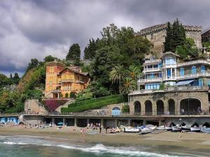 a group of people on a beach with buildings at CASA ELA in Levanto