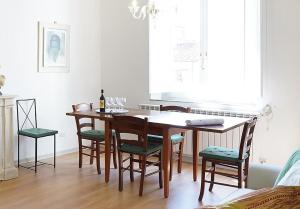 a dining room with a wooden table and chairs at Soderini Palace in Florence