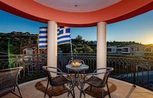 
a patio area with chairs, tables and umbrellas at Tsiolis Studios & Apartments in Tsilivi
