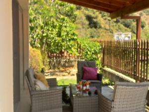 a patio with two chairs and a table on a porch at Protopapas House in Kato Amiandos